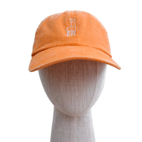 An orange baseball hat with a white alpaca logo, displayed on a mannequin head.
