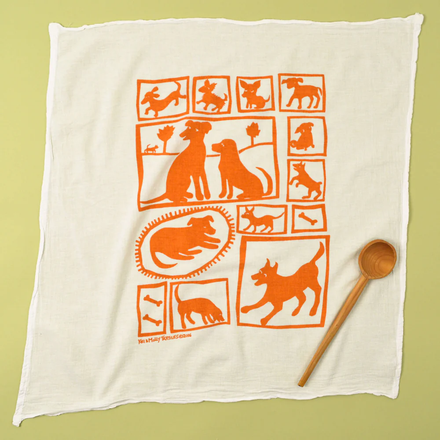 White towel with orange dog illustrations on a green background